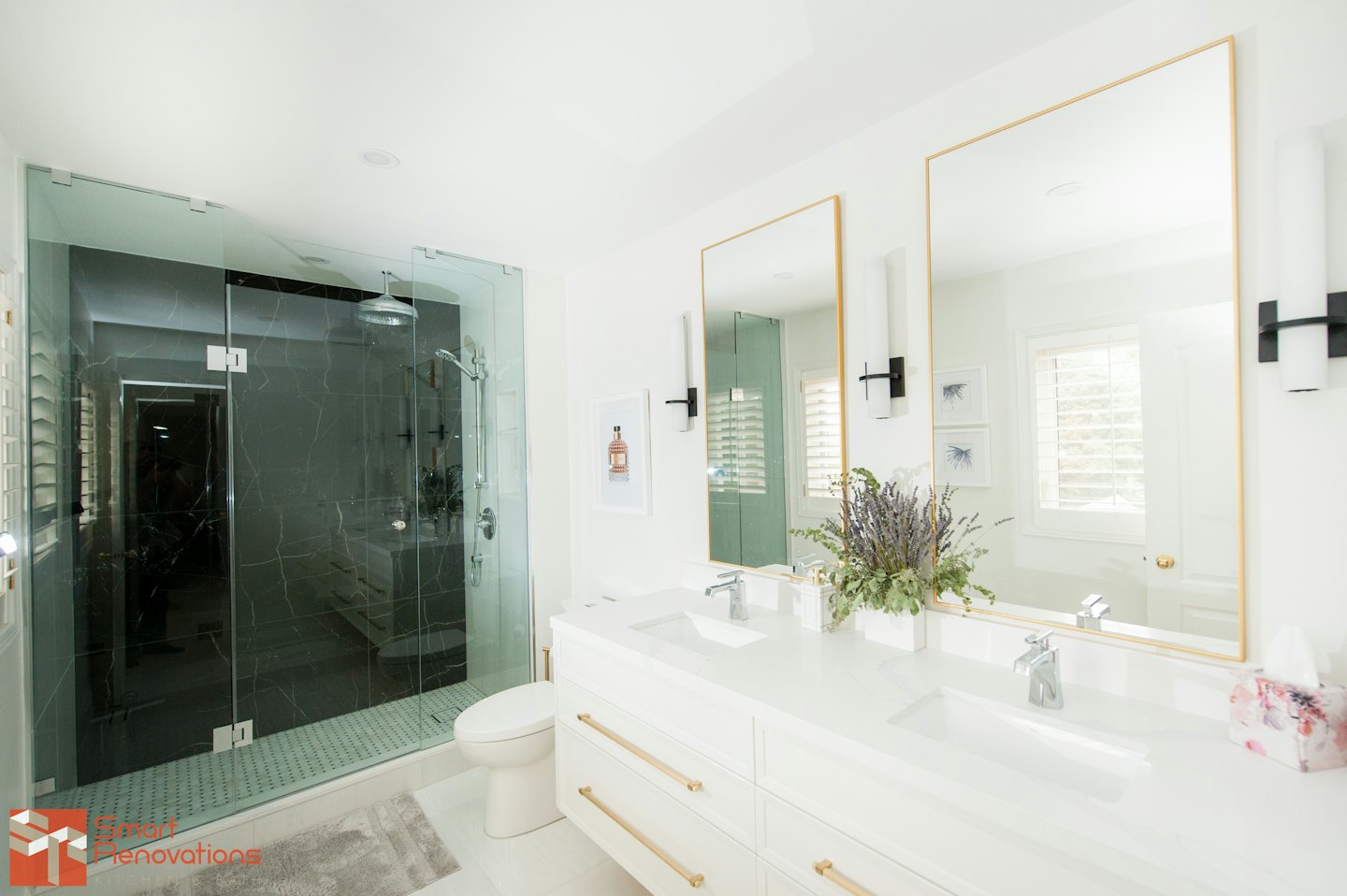 Modern bathroom with glass shower and double vanity.